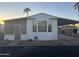 Single-wide manufactured home with carport and screened porch at 9427 E University Dr # 46, Mesa, AZ 85207
