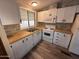 Updated kitchen with white cabinets and gas range at 9427 E University Dr # 46, Mesa, AZ 85207