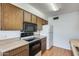 View of kitchen with wood cabinets and appliances at 9523 W North Ln # B, Peoria, AZ 85345