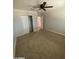 Bedroom with ceiling fan, carpet, and closet at 1011 W Northern Ave, Phoenix, AZ 85021