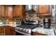 Modern kitchen features granite countertops, stainless steel gas cooktop and range hood at 1011 W Northern Ave, Phoenix, AZ 85021