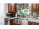 Kitchen with farmhouse sink, granite countertops, and dark wood cabinets at 1011 W Northern Ave, Phoenix, AZ 85021