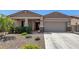 Tan two-story house with a two-car garage and desert landscaping at 12667 E Nandina Pl, Gold Canyon, AZ 85118