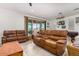 Relaxing living room features comfortable leather reclining sofas and plenty of natural light at 12667 E Nandina Pl, Gold Canyon, AZ 85118