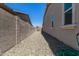 Side yard with gravel ground cover and a view of a block wall and house at 12667 E Nandina Pl, Gold Canyon, AZ 85118