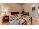 Cozy bedroom featuring a floral comforter and wood nightstand at 17200 W Bell Rd # 1218, Surprise, AZ 85374