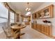 Kitchen and dining area with wood cabinets and table for two at 17200 W Bell Rd # 1218, Surprise, AZ 85374