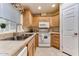 Well-equipped kitchen with light wood cabinets and stainless steel sink at 17200 W Bell Rd # 1218, Surprise, AZ 85374