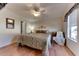 Main bedroom with king-size bed, hardwood floors and ceiling fan at 17200 W Bell Rd # 1218, Surprise, AZ 85374