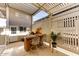 Outdoor kitchen with built-in grill, sink, mini-fridge, and bar seating at 17200 W Bell Rd # 1218, Surprise, AZ 85374