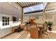 Outdoor kitchen with built-in grill, sink, mini-fridge, and bar seating at 17200 W Bell Rd # 1218, Surprise, AZ 85374
