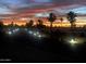 Evening street view with palm trees and lighting at 17200 W Bell Rd # 1218, Surprise, AZ 85374