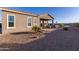 Landscaped backyard with covered patio and pool at 18668 W Chuckwalla Canyon Rd, Goodyear, AZ 85338