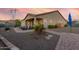 Covered patio and gravel backyard with pool and mountain views at 18668 W Chuckwalla Canyon Rd, Goodyear, AZ 85338