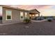 Desert landscape with covered patio, pool, and built-in BBQ at 18668 W Chuckwalla Canyon Rd, Goodyear, AZ 85338