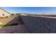 Landscaped backyard with block wall and distant mountain views at 18668 W Chuckwalla Canyon Rd, Goodyear, AZ 85338