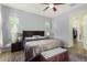 Bright bedroom with king-size bed, walk-in closet, and ceiling fan at 18668 W Chuckwalla Canyon Rd, Goodyear, AZ 85338