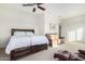 Bright bedroom with a large bed and sitting area at 18668 W Chuckwalla Canyon Rd, Goodyear, AZ 85338