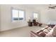 Relaxing bedroom with a recliner, sofa, and large windows at 18668 W Chuckwalla Canyon Rd, Goodyear, AZ 85338