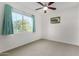 Well-lit bedroom with large window and neutral decor at 18668 W Chuckwalla Canyon Rd, Goodyear, AZ 85338