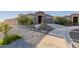 Well-maintained front yard with desert landscaping and a large driveway at 18668 W Chuckwalla Canyon Rd, Goodyear, AZ 85338