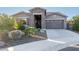 Single-story home with stone accents and a two-car garage at 18668 W Chuckwalla Canyon Rd, Goodyear, AZ 85338