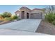 Single-story home with stone accents and a two-car garage at 18668 W Chuckwalla Canyon Rd, Goodyear, AZ 85338