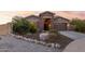 Stunning curb appeal with stone accents and a welcoming front porch at 18668 W Chuckwalla Canyon Rd, Goodyear, AZ 85338