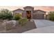 Landscaped front yard with desert plants and a large driveway at 18668 W Chuckwalla Canyon Rd, Goodyear, AZ 85338