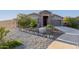 House exterior with stone accents, well-manicured lawn, and driveway at 18668 W Chuckwalla Canyon Rd, Goodyear, AZ 85338