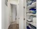 Bright hallway with linen closet and access to bedrooms at 18668 W Chuckwalla Canyon Rd, Goodyear, AZ 85338