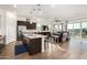 Open concept kitchen with an island and dark cabinetry at 18668 W Chuckwalla Canyon Rd, Goodyear, AZ 85338