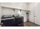 Laundry room with washer, dryer, and overhead shelving at 18668 W Chuckwalla Canyon Rd, Goodyear, AZ 85338