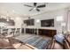 Open living space with a modern kitchen and a large TV at 18668 W Chuckwalla Canyon Rd, Goodyear, AZ 85338