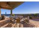 Covered patio furniture with a view of the pool and landscaping at 18668 W Chuckwalla Canyon Rd, Goodyear, AZ 85338