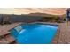 Inviting pool with waterfall feature and spacious patio at 18668 W Chuckwalla Canyon Rd, Goodyear, AZ 85338