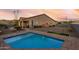 Relaxing rectangular pool with brick coping and grassy area at 18668 W Chuckwalla Canyon Rd, Goodyear, AZ 85338