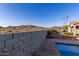 View of backyard pool and block wall with mountain views at 18668 W Chuckwalla Canyon Rd, Goodyear, AZ 85338
