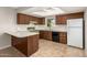 Galley kitchen with wood cabinets and built-in appliances at 2460 W Jacinto Ave, Mesa, AZ 85202