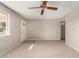 Bright living room with neutral carpeting and ceiling fan at 2460 W Jacinto Ave, Mesa, AZ 85202