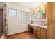 Bathroom with wood cabinets and tile floor at 2716 E Voltaire Ave, Phoenix, AZ 85032