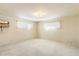 Simple bedroom with carpet flooring and large windows at 2716 E Voltaire Ave, Phoenix, AZ 85032