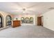 Bright living room with a wet bar, large windows, and a ceiling fan at 2716 E Voltaire Ave, Phoenix, AZ 85032