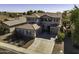 Two-story house with gray siding, a three-car garage, and a backyard pool at 297 W Seaside Dr, Casa Grande, AZ 85122