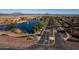 Community overview featuring a lake, road, and lush landscaping at 297 W Seaside Dr, Casa Grande, AZ 85122