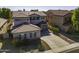 Two-story house with gray siding, a three-car garage, and a landscaped yard at 297 W Seaside Dr, Casa Grande, AZ 85122