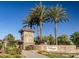 Elegant community entrance with palm trees and signage at 297 W Seaside Dr, Casa Grande, AZ 85122