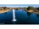 High-angle view of a pristine community lake featuring a tall water fountain at 297 W Seaside Dr, Casa Grande, AZ 85122