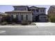 Two-story house with gray siding, a three-car garage, and landscaping at 297 W Seaside Dr, Casa Grande, AZ 85122