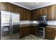 Modern kitchen with stainless steel appliances and wood cabinets at 297 W Seaside Dr, Casa Grande, AZ 85122